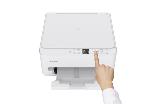 Imprimante Canon PIXMA blanche avec capot scanner ouvert et photo de paysage sortant du bac