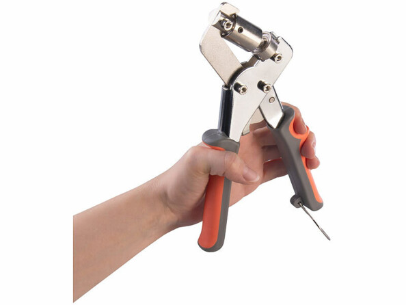 pince à oeillets métallique tenue par une main