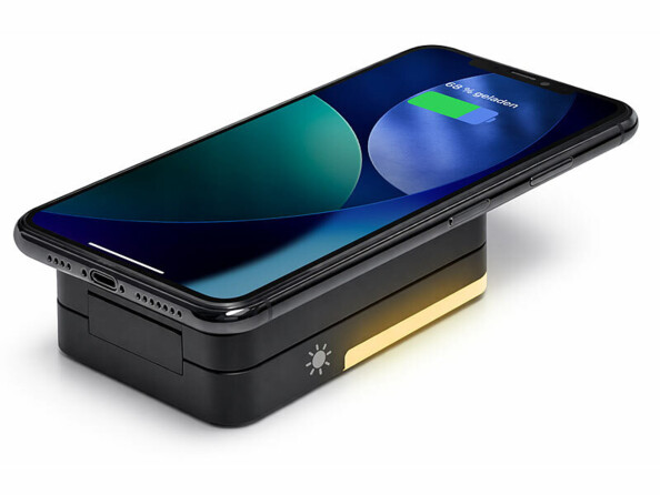 Station de chargement compatible MagSafe repliée avec smartphone en charge et lampe LED allumée