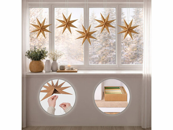 5 étoiles pliables en carton en décoration sur une baie vitrée