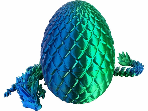dragon imprimé en 3D articulé posé à coté de son oeuf
