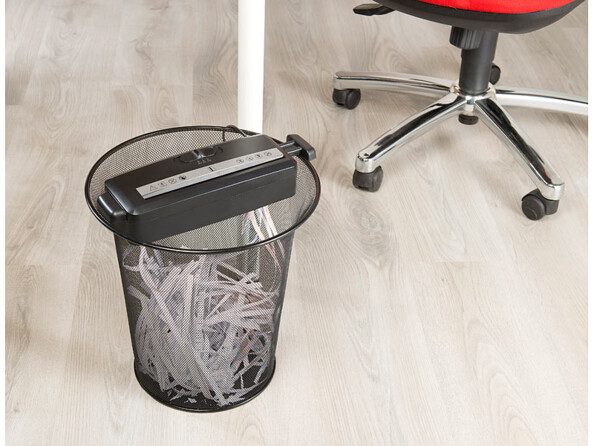 Couvercle de la déchiqueteuse A4 General Office sur une poubelle en métal rempli de documents déchiquetés