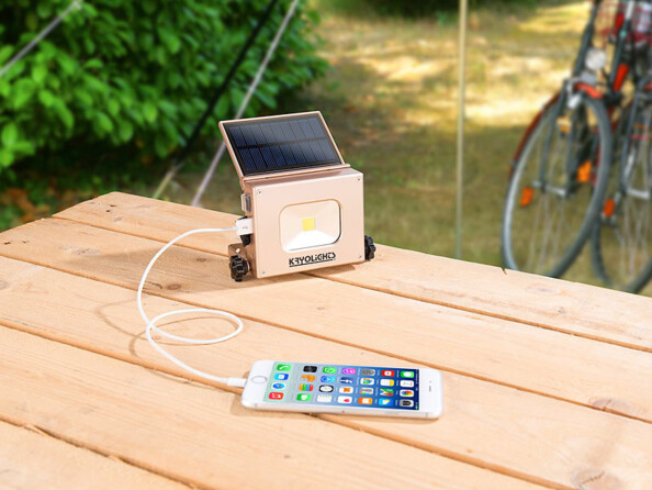 Projecteur à LED COB et batterie d'appoint en train de charger un smartphone