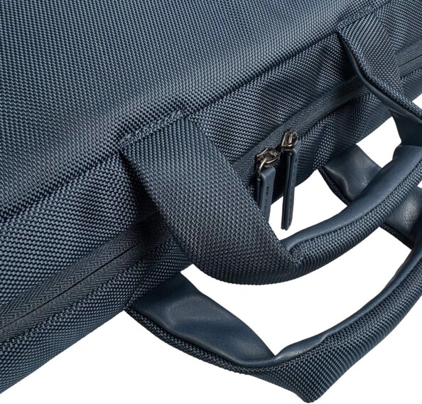 Zoom sur la double fermeture éclair du compartiment principal de la sacoche de transport pour ordi portable couchée