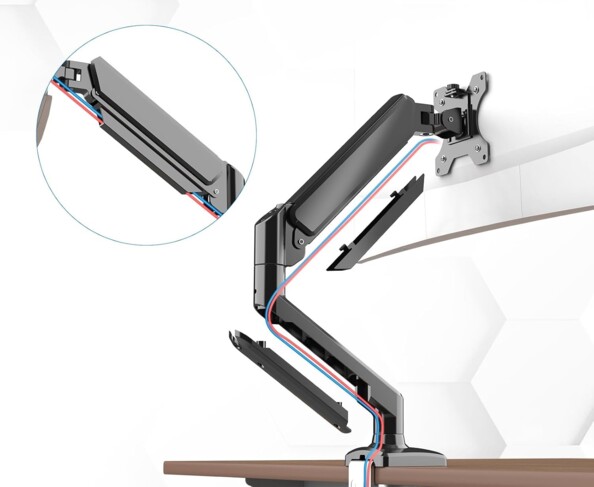 Gros plan sur le passe-câbles intégré sous forme de goulotte dans le support pour écran Grifema en alliage d'aluminium coloris noir