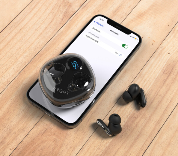 Écouteurs RYGHT GHOST noirs sur surface bois avec boîtier transparent et smartphone affichant Bluetooth