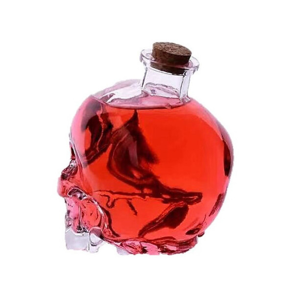 Flacon en forme de tête de mort rempli d'un liquide rougeâtre