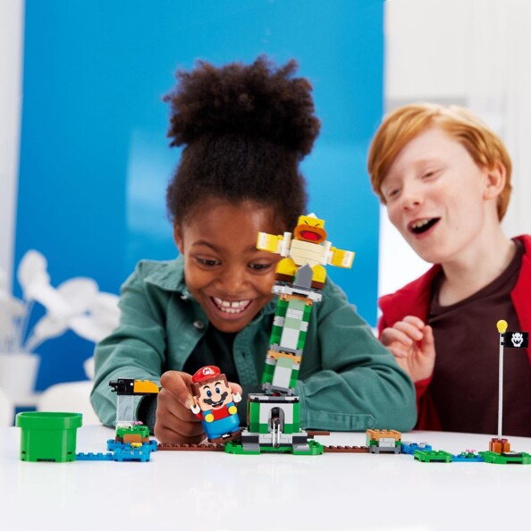 Enfants s'amusent et la tour Lego bascule
