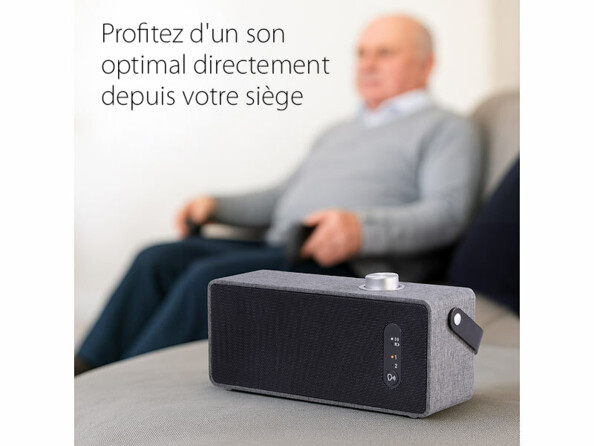 Haut-parleur TV auvisio posé près d’un canapé pour écoute individuelle