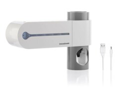 Stérilisateur UV pour brosses à dents avec support et distributeur de dentifrice.