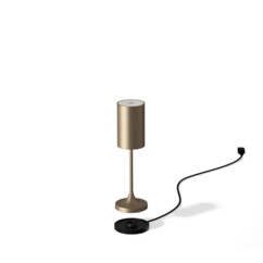 Lampe avec abat-jour sans fil coloris champagne brossé en lévitation au-dessus de sa base chargement filaire secteur