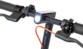 Gros plan guidon de trottinette Ducati Pro II avec phare LED allumé sonnette et poignées noires