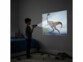 Lampe torche projecteur tenue par un enfant projetant un dinosaure sur un mur de nuit