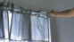 Rideaux à boucles et petits pois installé sur la tringle à rideau ajustable sur le cadre d'une fenêtre