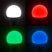 Mise en situation de l'ampoule connectée Luminea LAV-100.rgbw avec couleur d'éclairage réglable : 2700 K ou RVB (bleu, vert, rouge), illustration du produit allumé dans l'obscurité en 4 couleurs : blanc, rouge, vert et bleu